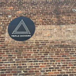 a brick wall with a sign on it