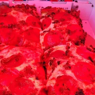 The pizza looks red because it&apos;s under a red umbrella in the sun was shining so that&apos;s what gave it that red hue.