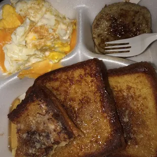 French toast platter with a fried hard egg w/ cheddar cheese on it &amp; two turkey sausage patties.