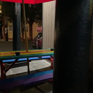 a colorful bench and umbrella