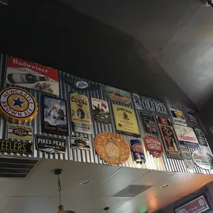 a bar with a lot of signs on the wall