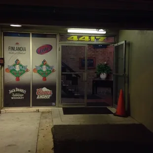 the entrance to a pizza shop