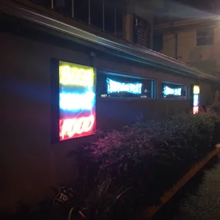 neon signs on the side of a building
