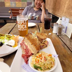 a woman sitting at a table with food