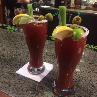 two bloody cocktails on a bar