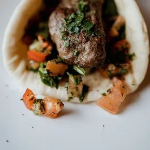 Our Lamb Kebab Pita Wrap paired with grilled vegetables, Tzatziki and a Fatoush medley wrapped in a warm pita.
