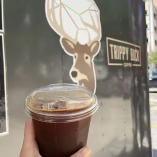 a hand holding a cup of coffee