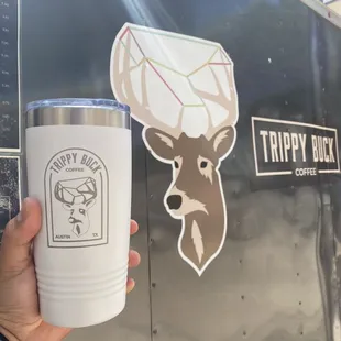 a hand holding a cup