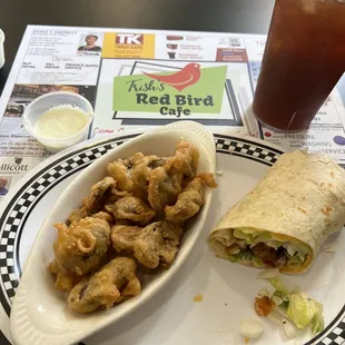 Half of my buffalo chicken wrap, fried mushrooms with ranch, and ice tea.