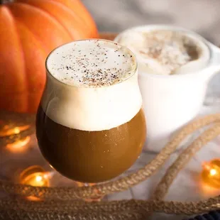 a glass of espresso next to a pumpkin