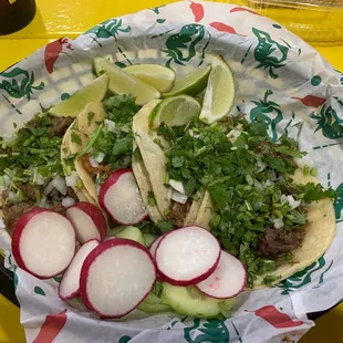 Four deliciously taco's with lots of radish, cucumber and lime for garnish.