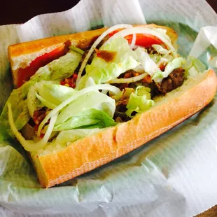 a sandwich with lettuce, tomato, and onions