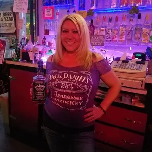 a woman standing in front of a bar