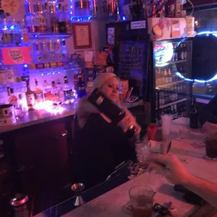 a bartender pouring a drink