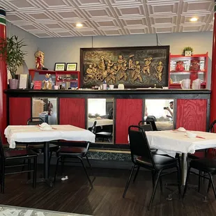 a dining area with tables and chairs