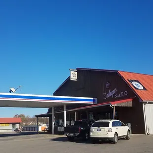 a gas station with cars parked in front of it