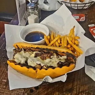a woman eating a hot dog and french fries