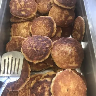 a pan of pancakes and a spatula