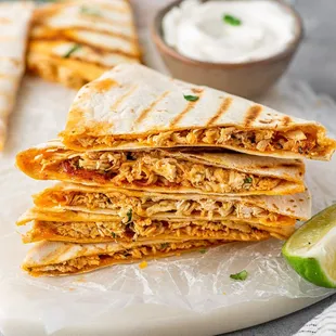 a stack of quesadillas on a cutting board