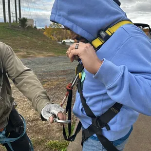 My husband getting his harness checked while we get strapped up.