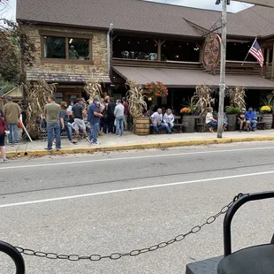 a crowd of people standing outside of a restaurant