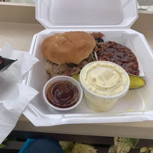 a pulled pork sandwich and sides