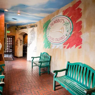 a green bench and two green chairs