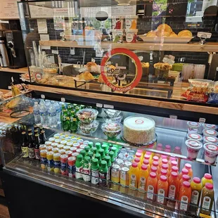 Cooler case with water, jombucha and juices with croissants in glass display