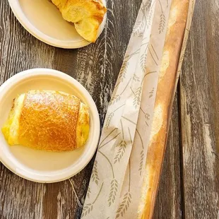 a croissant and bread on a table