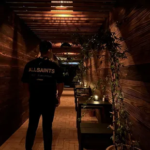 a man standing in a dimly lit restaurant