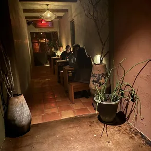 a couple of people sitting at a table in a dimly lit room