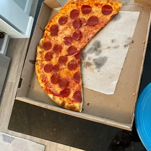 a half eaten pepperoni pizza