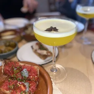 a plate of food and a drink on a table