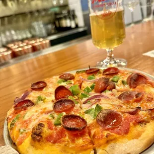 a pepperoni pizza and a glass of beer