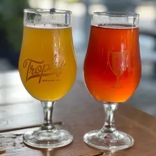 two glasses of beer on a table