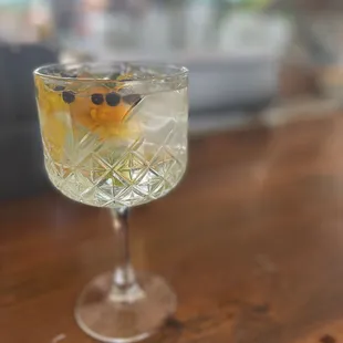 a glass of water with a garnish on top
