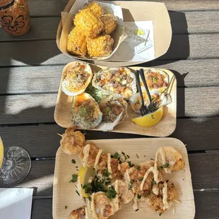 a variety of seafood dishes on wooden trays