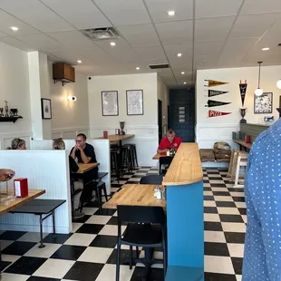 people sitting at tables in a restaurant