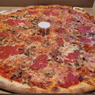 New York style pizza with double mushrooms and more sauce added on top.