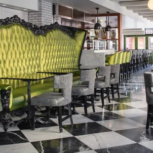 a green couch and chairs in a restaurant