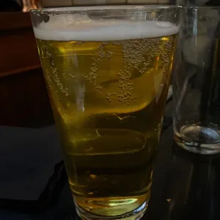 a glass of beer on a table
