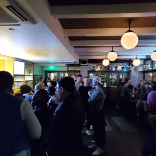 a large group of people sitting at a bar