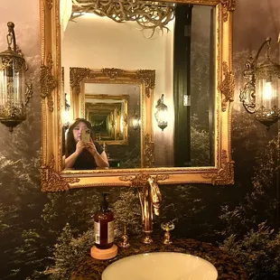 a woman taking a picture of herself in a mirror