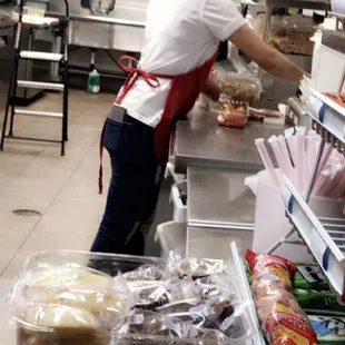 a woman preparing food in a kitchen