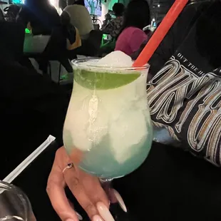 a woman holding a drink