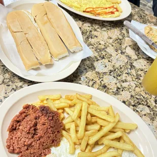 Onion omelette with fries, cuban bread, chorizo, fries and two fries eggs over easy.