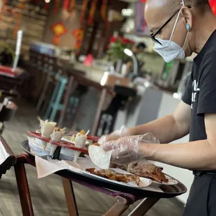 a man in a mask serving food