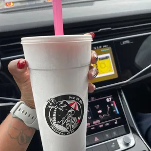 a woman holding a starbucks cup