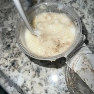a banana milkshake with a spoon in it
