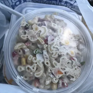 a bowl of pasta in a plastic container